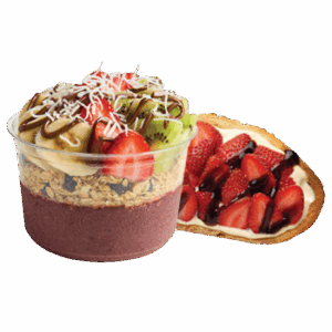 An acai bowl in a clear plastic cup layered with a purple smoothie base and granola, topped with banana slices, strawberries, kiwi, shredded coconut, and chocolate drizzle, placed next to a slice of toast topped with cream, fresh strawberries, and a drizzle of chocolate sauce.