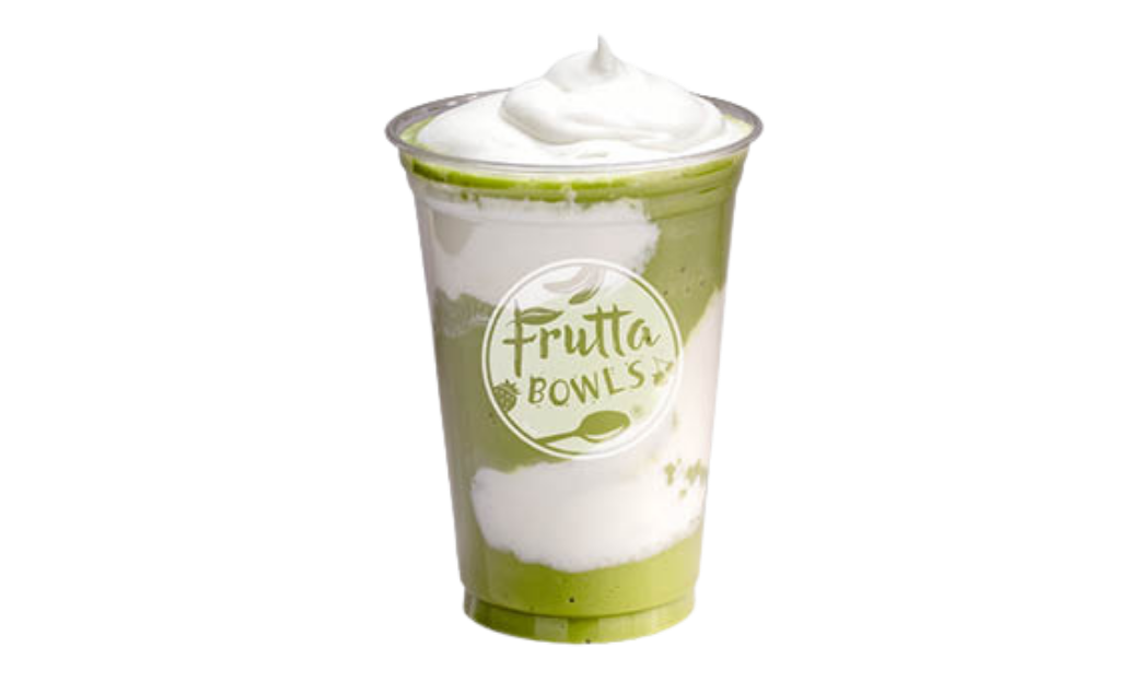 Clear plastic cup with a layered green and white drink topped with whipped cream and Frutta Bowls logo on a light gray background.